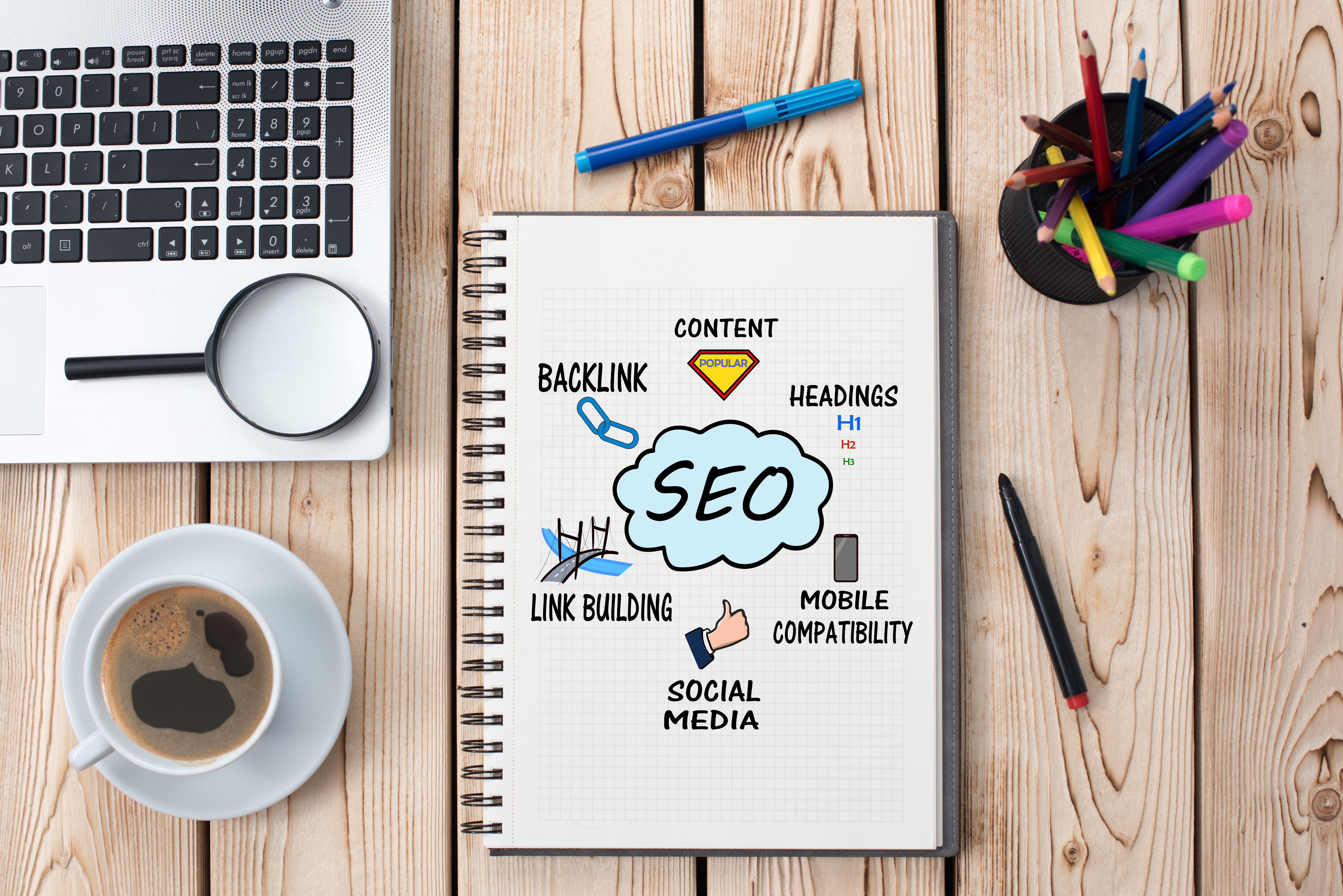 notebook open on a table with SEO information written down